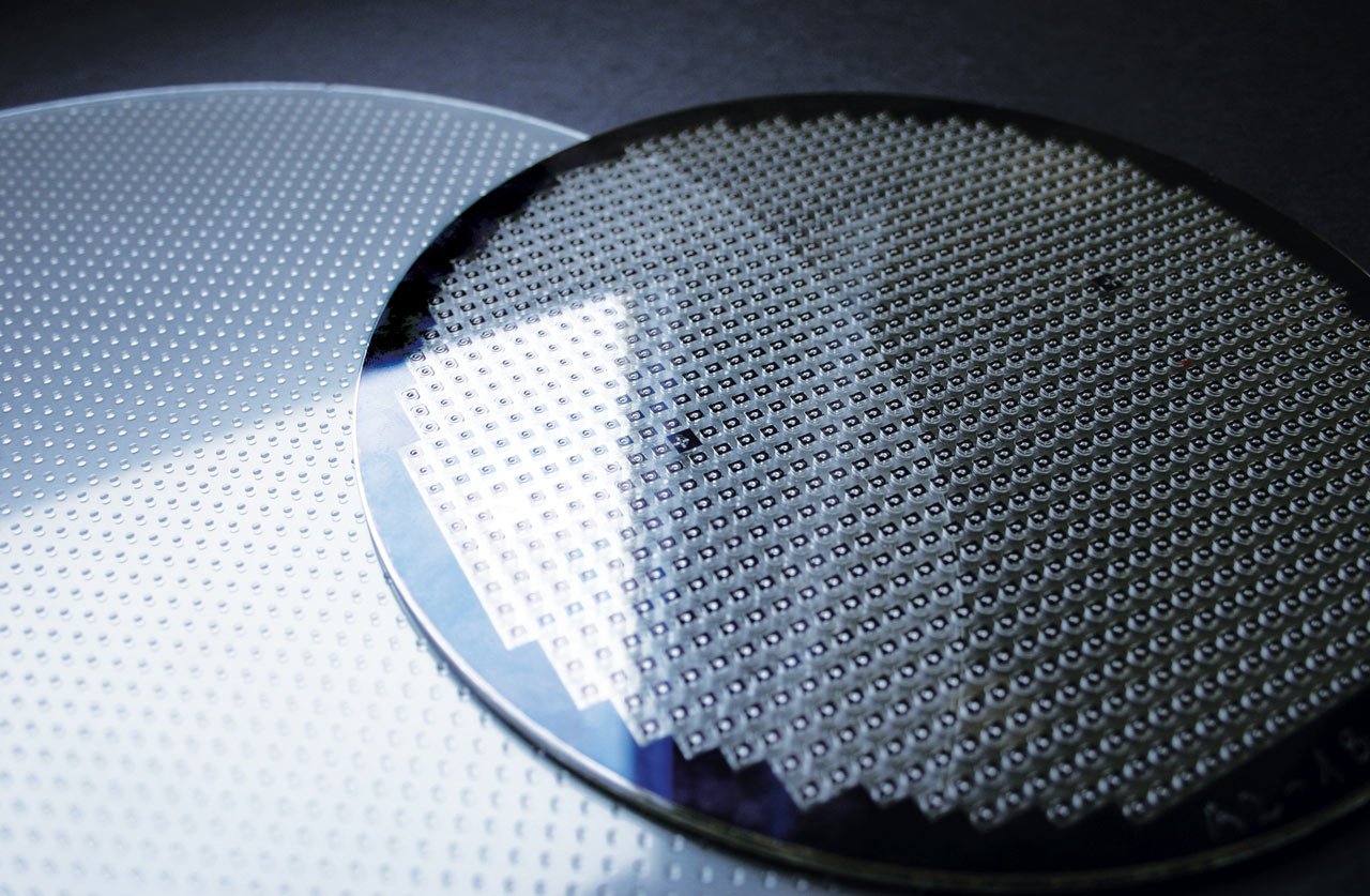 Photograph of lens wafer and a stacked wafer with fully functional optical modules